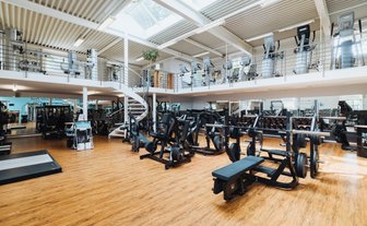 BUDGET Fitness Frick: Stimmungsbild lichtdurchlutete Trainingshalle mit neusten Plate-loaded Kraftgeräten von Technogym